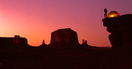 silhouette of a camper on a cliff at sunrise, sunset. Travel photography by Don B. Stevenson